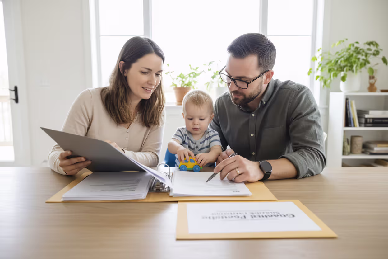 Parents reviewing guardianship and estate planning documents with their child nearby